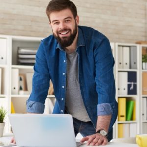 bearded-man-enjoying-work-in-office-CWVFUBT.jpg